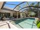 Screened in pool and spa featuring a brick deck, privacy, and mature landscaping at 3607 Berger Rd, Lutz, FL 33548