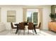 Elegant dining room with dark table, leather chairs and art at 4023 Northern Key Dr, Plant City, FL 33563
