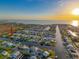 Aerial view of waterfront homes on canals with sunset, showcasing community living and waterfront access at 4116 Diaz Ct, Hernando Beach, FL 34607
