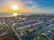 Aerial view of waterfront community with home of interest marked by red arrow at sunset at 4116 Diaz Ct, Hernando Beach, FL 34607