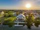 Waterfront home aerial view with dock and surrounding community near the ocean at sunset at 4116 Diaz Ct, Hernando Beach, FL 34607