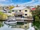 Waterfront home features a private dock, tiki bar, patio, and ample outdoor seating for entertaining at 4116 Diaz Ct, Hernando Beach, FL 34607