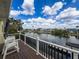 Balcony with chairs overlooks a tranquil canal, offering a serene spot to relax and enjoy scenic water views at 4116 Diaz Ct, Hernando Beach, FL 34607