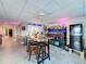 Finished basement area with bar, stools, and fun lighting for entertaining guests at 4116 Diaz Ct, Hernando Beach, FL 34607