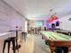 Basement recreation area with pool table, bar, and updated decorative brick accent wall at 4116 Diaz Ct, Hernando Beach, FL 34607