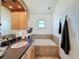 Bathroom features a bathtub with tile surround, a wood vanity, and a wall-mounted television at 4116 Diaz Ct, Hernando Beach, FL 34607
