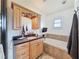 Bright bathroom features a vanity with cabinets, granite counters, and a soaking tub at 4116 Diaz Ct, Hernando Beach, FL 34607