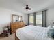 Bright bedroom featuring a large dresser with mirror and two windows with blinds and curtains at 4116 Diaz Ct, Hernando Beach, FL 34607