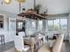 Sunroom dining area with long table, french doors and views of the outside at 4116 Diaz Ct, Hernando Beach, FL 34607