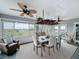 Sunroom dining area with large windows, ceiling fan, and views of the landscape at 4116 Diaz Ct, Hernando Beach, FL 34607