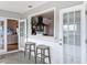 View of dining area, showcasing passthrough to kitchen and access to French patio doors at 4116 Diaz Ct, Hernando Beach, FL 34607