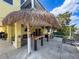 View of the home's exterior with a covered patio, tiki bar, and seating area for entertaining at 4116 Diaz Ct, Hernando Beach, FL 34607