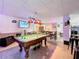 Entertaining basement game room with a pool table, bar area, and modern lighting at 4116 Diaz Ct, Hernando Beach, FL 34607