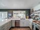 Bright kitchen featuring granite countertops, stainless steel appliances, and a large window with a serene view at 4116 Diaz Ct, Hernando Beach, FL 34607