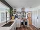 A pristine kitchen design with a stainless steel range, custom hood, and view to an adjoining room at 4116 Diaz Ct, Hernando Beach, FL 34607