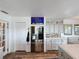 Bright kitchen with stainless steel refrigerator, white cabinetry, and an adjacent doorway at 4116 Diaz Ct, Hernando Beach, FL 34607