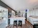 A sleek kitchen includes bar seating, stainless steel appliances, and windows offering panoramic views at 4116 Diaz Ct, Hernando Beach, FL 34607