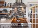 Modern kitchen with tile backsplash and shelving next to stainless steel stove at 4116 Diaz Ct, Hernando Beach, FL 34607