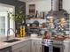Updated kitchen showcasing the stainless steel appliances, vent hood, backsplash and wood shelving at 4116 Diaz Ct, Hernando Beach, FL 34607