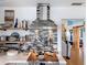A modern stove and backsplash add flair to this kitchen design with wood shelving and decorative pots at 4116 Diaz Ct, Hernando Beach, FL 34607