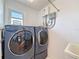 Laundry room features a modern washer and dryer and an utility sink at 4116 Diaz Ct, Hernando Beach, FL 34607