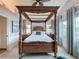 Luxury main bedroom featuring a four-poster bed, bedside tables, and large windows at 4116 Diaz Ct, Hernando Beach, FL 34607