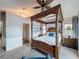 Spacious main bedroom with a four poster bed and adjoining door at 4116 Diaz Ct, Hernando Beach, FL 34607