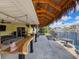 Outdoor bar area with ceiling fans, patio seating, and a full view of the waterfront at 4116 Diaz Ct, Hernando Beach, FL 34607