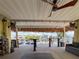 Outdoor bar area with seating, ceiling fans, a covered tiki bar, and canal views at 4116 Diaz Ct, Hernando Beach, FL 34607