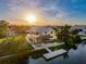 An aerial view of a waterfront home with a patio, tiki bar and a private boat dock at 4116 Diaz Ct, Hernando Beach, FL 34607