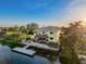 An aerial view of a waterfront home with a dock, patio and spacious backyard perfect for entertaining at 4116 Diaz Ct, Hernando Beach, FL 34607