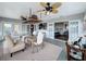 Spacious sunroom with tile floors, unique lighting, and access to the kitchen and outdoor patio at 4116 Diaz Ct, Hernando Beach, FL 34607
