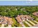 Aerial of townhomes in a lush, tree-filled community, with views of nearby amenities at 456 Lakeview Dr # 5, Palm Harbor, FL 34683