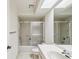 Bathroom features a vanity, skylight and shower/tub combo with glass doors at 456 Lakeview Dr # 5, Palm Harbor, FL 34683