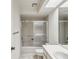 Bathroom featuring tub with sliding glass doors, and double sinks at 456 Lakeview Dr # 5, Palm Harbor, FL 34683