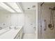 Clean bathroom showcasing a vanity with sink, toilet, and tiled walk-in shower at 456 Lakeview Dr # 5, Palm Harbor, FL 34683