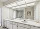 Bathroom with double sinks, and a large mirror and shower at 456 Lakeview Dr # 5, Palm Harbor, FL 34683