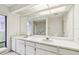 Main bathroom featuring dual sinks, bright lighting, and a large mirror at 456 Lakeview Dr # 5, Palm Harbor, FL 34683