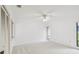 Spacious, well-lit bedroom with neutral carpet, ceiling fan and outdoor view at 456 Lakeview Dr # 5, Palm Harbor, FL 34683