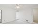 This bedroom is painted white, with a ceiling fan and a window with blinds at 456 Lakeview Dr # 5, Palm Harbor, FL 34683