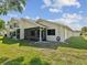 Exterior rear view of townhome showcasing screened lanai, siding, and landscaping at 456 Lakeview Dr # 5, Palm Harbor, FL 34683