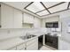 Bright kitchen with white cabinets and black appliances at 456 Lakeview Dr # 5, Palm Harbor, FL 34683