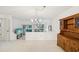 Bright living room with neutral carpet, wooden china cabinet, and natural light at 456 Lakeview Dr # 5, Palm Harbor, FL 34683