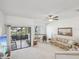 Open living room featuring a ceiling fan, sliding glass doors to a screened lanai, and neutral decor at 456 Lakeview Dr # 5, Palm Harbor, FL 34683