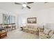 Bright living room featuring neutral carpet, floral sofa, ceiling fan, and natural light at 456 Lakeview Dr # 5, Palm Harbor, FL 34683