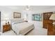 Comfortable main bedroom with a bright window, neutral carpet and furniture at 456 Lakeview Dr # 5, Palm Harbor, FL 34683