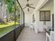 Covered patio with ceiling fan and screen, overlooking well-manicured lawn at 456 Lakeview Dr # 5, Palm Harbor, FL 34683