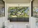 Enclosed patio with an outdoor view of mature trees and well-kept lawns at 456 Lakeview Dr # 5, Palm Harbor, FL 34683