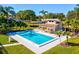 Community pool surrounded by palm trees and lounge chairs for relaxation at 456 Lakeview Dr # 5, Palm Harbor, FL 34683