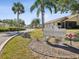 The Townhomes of Westlake Village community sign is surrounded by green landscaping at 456 Lakeview Dr # 5, Palm Harbor, FL 34683